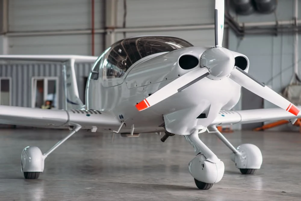 Single-engine training aircraft in a hangar — Commercial Pilot Ground School